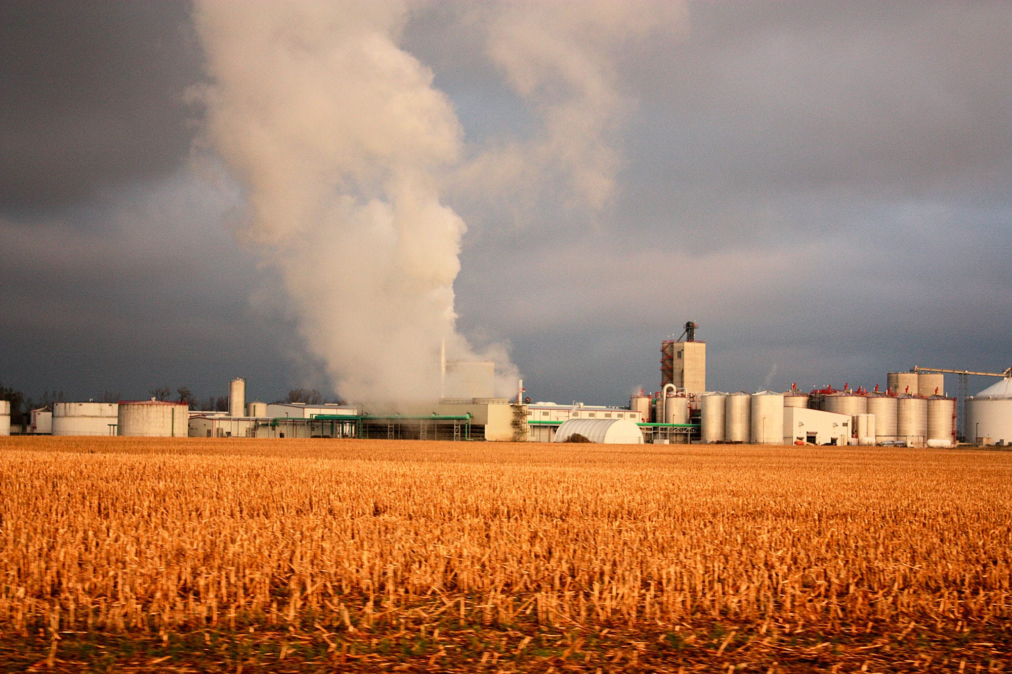 landscape-stormy-sky-factory-farm-field