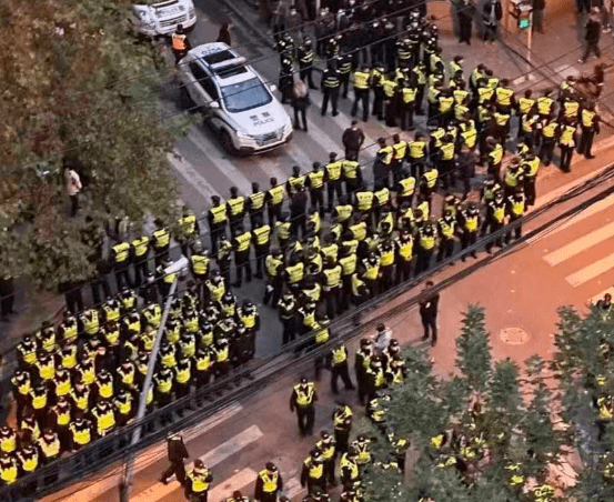 Police fortifying the intersection in Shanghai that became the rallying point of the protests Image fair use